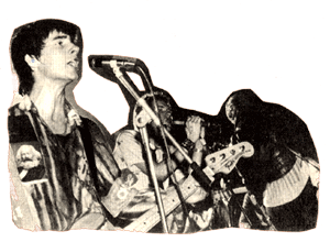Cutout of Glen Matlock playing bass and singing
