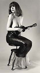 Carol Lipnik dressed as mermaid playing ukelele